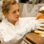 young girl carving a bird