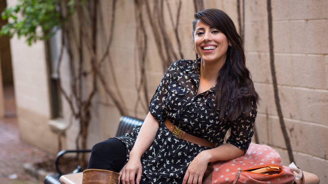 Woman leaning on chair, smiling