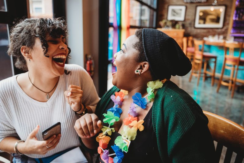 Two individuals laugh together