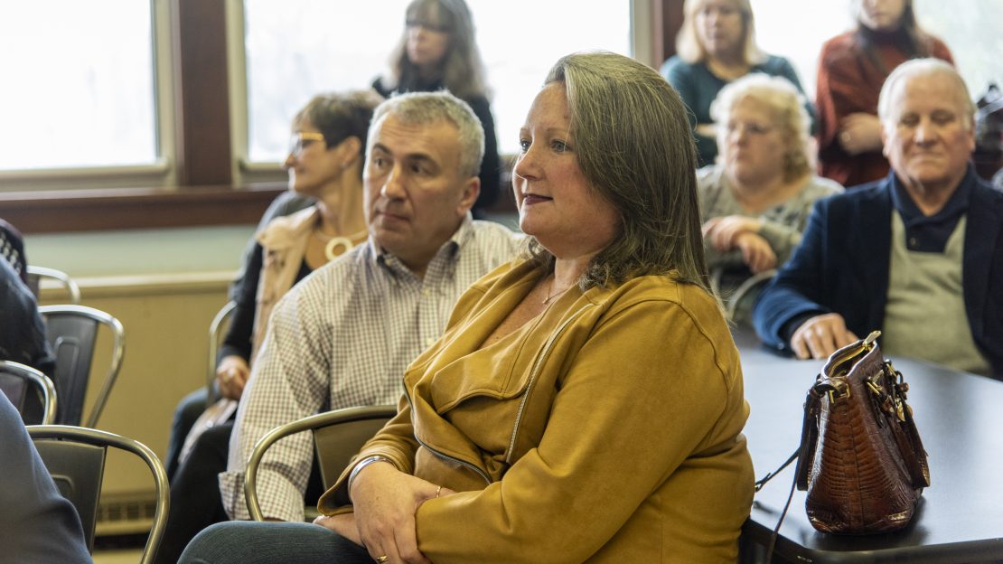 Close up of woman sitting at project activate event