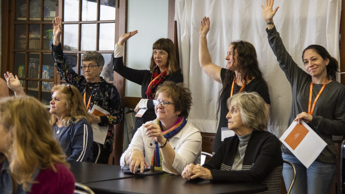 Photo of women raising their hands