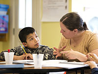 Woman helps child with homework