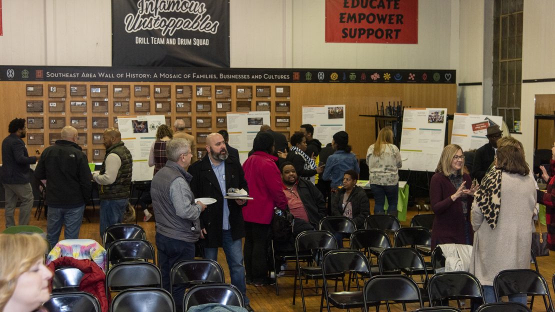 Photo of project activate event, tables are set up around the perimeter