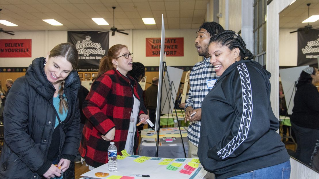 Four people talking at project activate event