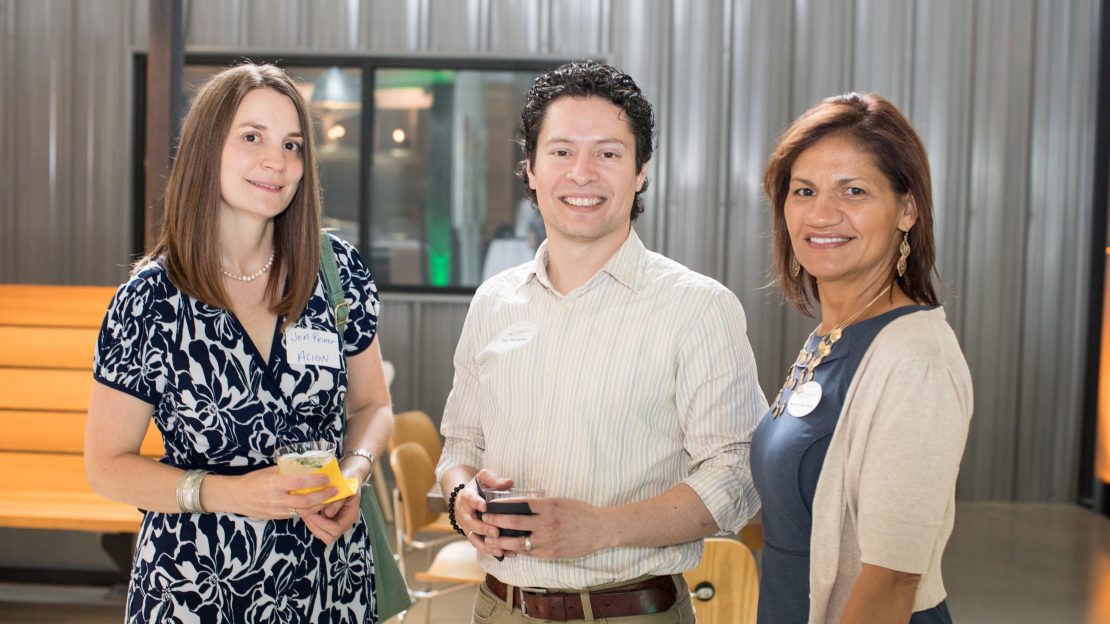 Three people smiling at camera