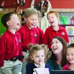 Group of children sit with a teacher