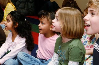 group of children sitting and looking away from the camera