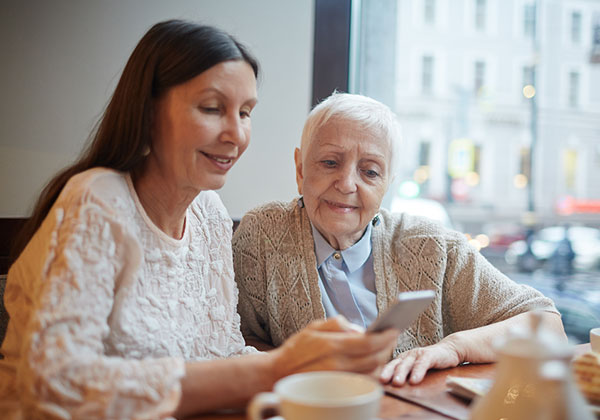 Two women look at a phone
