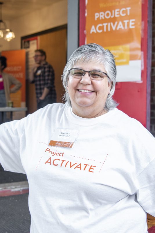 Woman smiles in project activate shirt