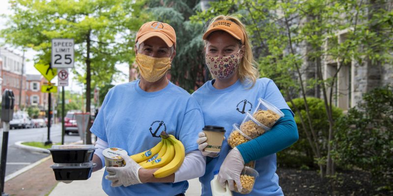 Two people hold snacks