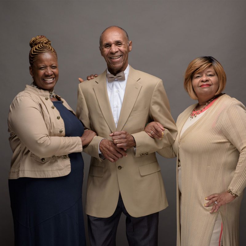 Portrait of the Polite family, wearing tan colored business wear