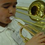 Close up of a young boy playing a musical instrument
