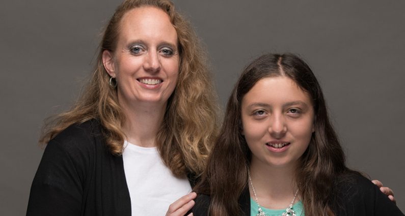 Portrait of mother and daughter smiling