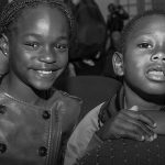 photo of two children smiling at the camera